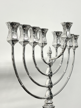 Silver Menorah with eight candles on a white background