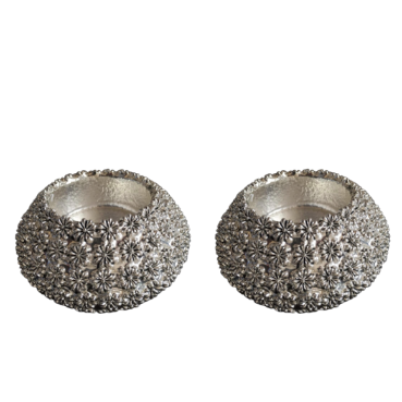 Two silver textured candle holders on a white background
