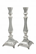 Two silver candle holders on a white background