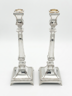 Two silver 925 candlesticks on a white background