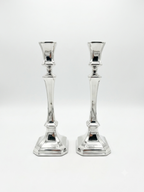 Two sterling silver 925 candlesticks on a white background