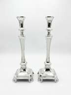 Pair of silver candlesticks on a white background