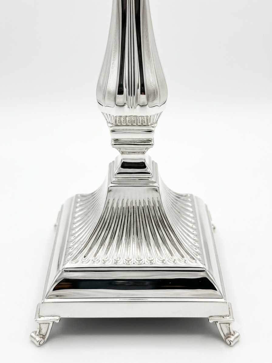 Pair of silver 925 candlesticks with intricate designs on a white background
