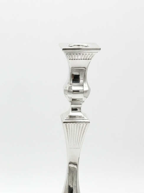 Two silver candlesticks on a white background