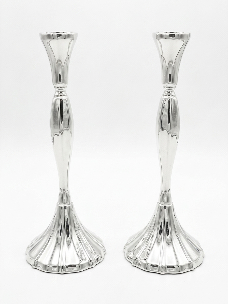 Two silver candle holders on a white background