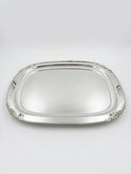 Silver tray with decorative edges on a white background
