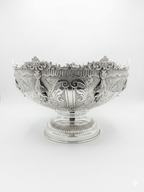 Decorative silver bowl with intricate engravings on a white background