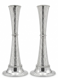 Two silver candle holders with textured design on a white background