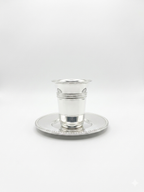 Silver cup and saucer set on a white background