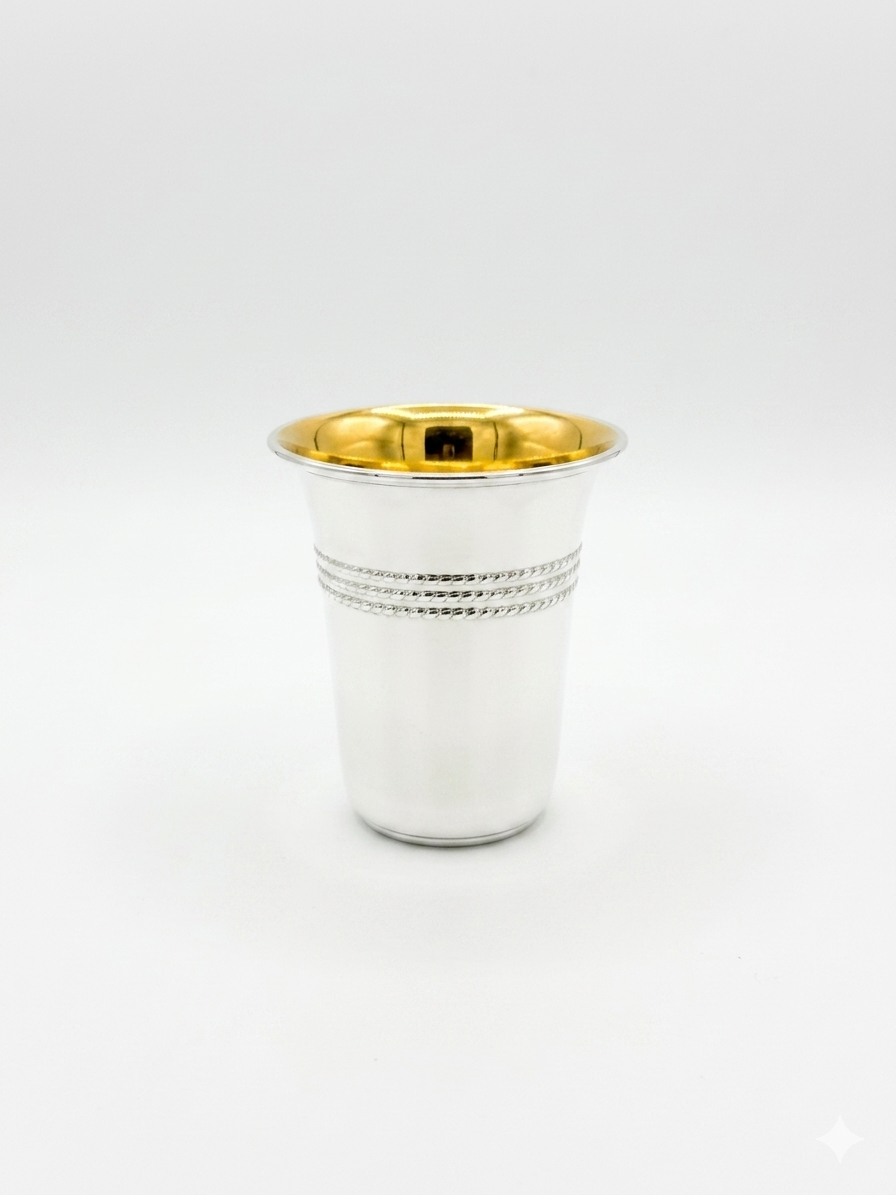 Silver cup with gold interior on a white background