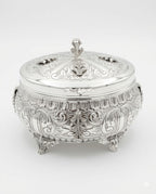 Decorative silver etrog box with intricate engravings on a white background