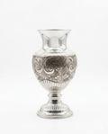 Silver vase with intricate patterns on a white background