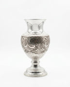 Silver vase with intricate patterns on a white background