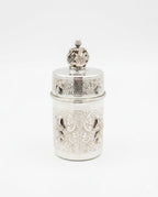 Decorative silver toothpick holder with wooden toothpicks on a white background