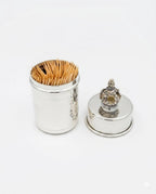 Silver toothpick holder with decorative top on a white background