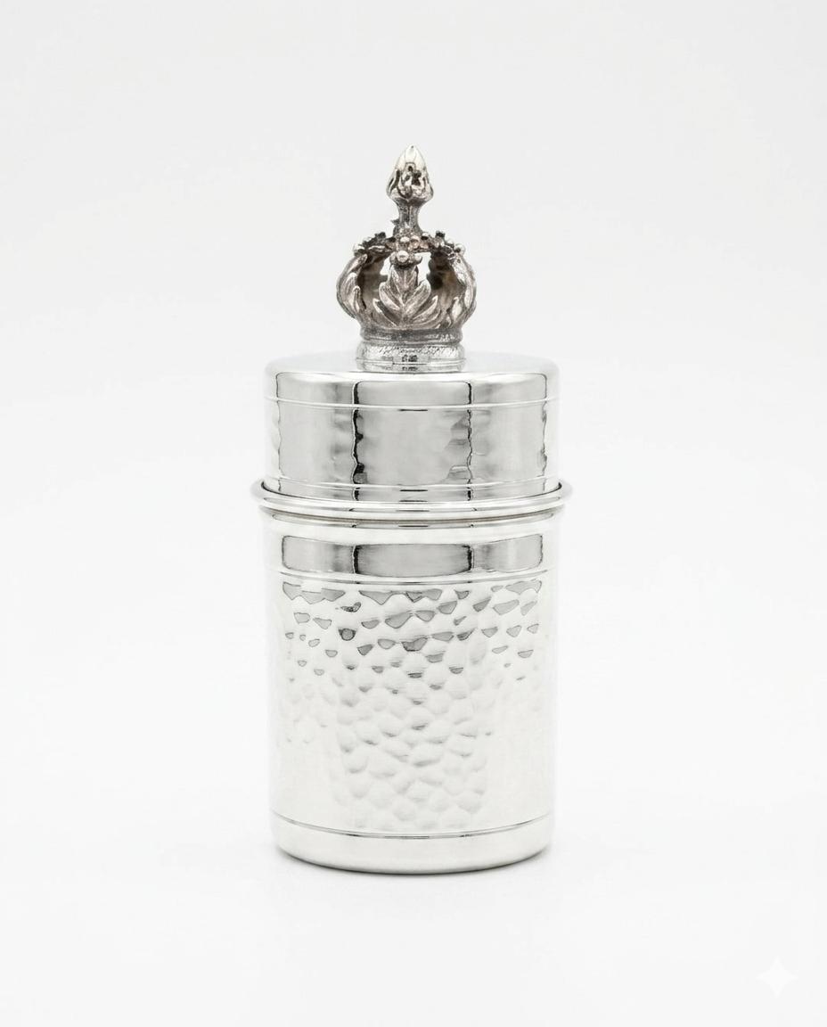 Silver toothpick holder with decorative top on a white background