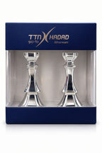 Two silver candlesticks in a TTN Hadad branded box on a white background