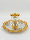 Silver and gold kiddush set on a white background
