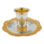 Silver and gold kiddush set on a white background