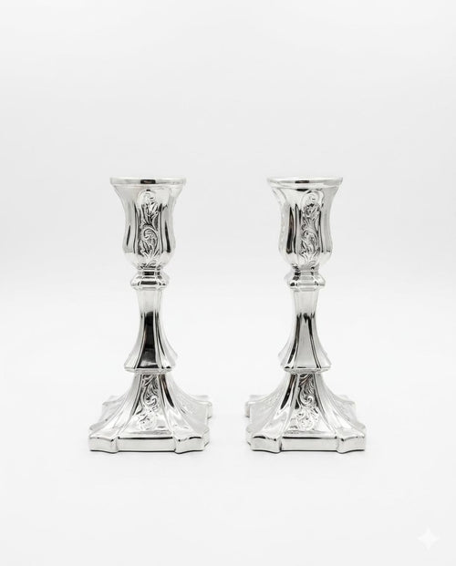 Pair of silver candlesticks on a white background