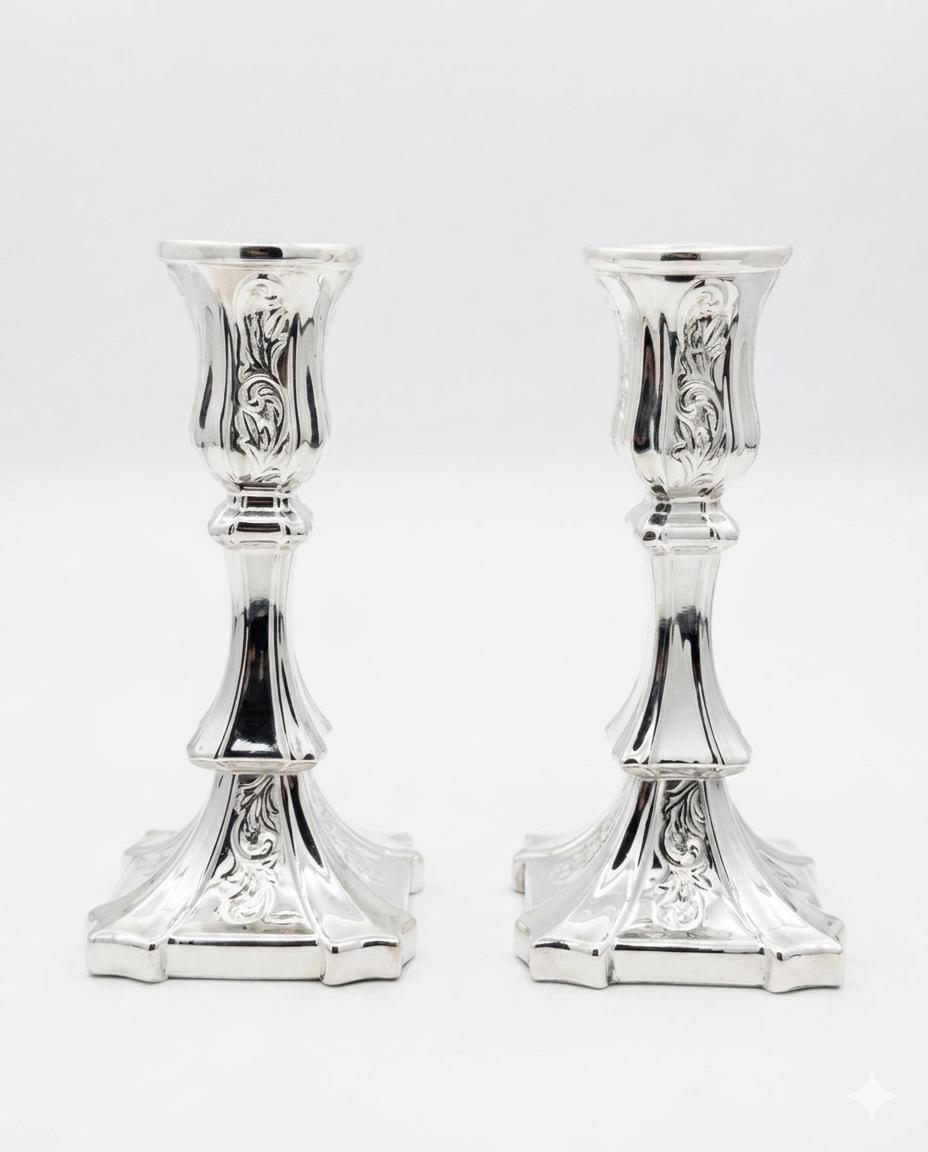 Pair of silver candlesticks on a white background