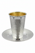 Silver and gold kiddush cup with matching saucer on a white background