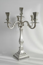 Silver candelabra with three candle holders on a white background