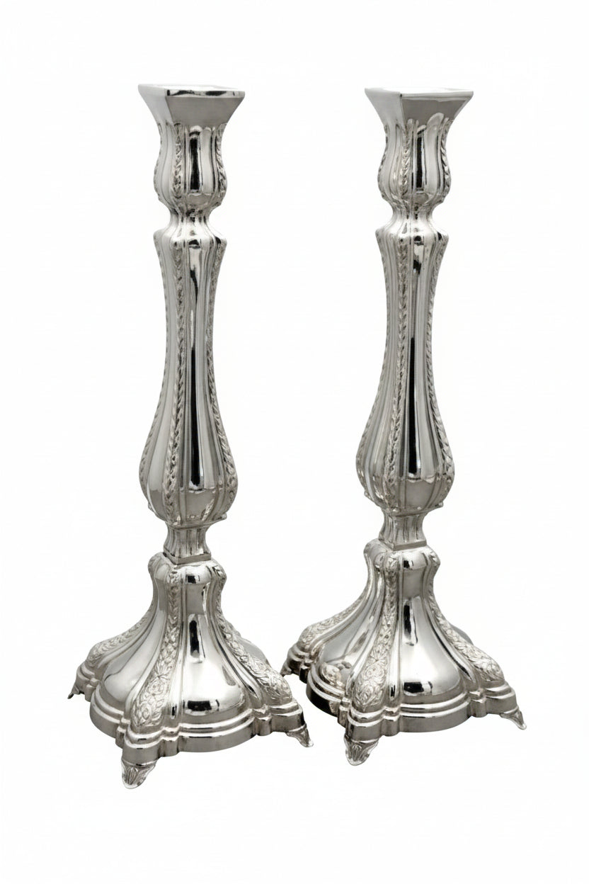 Two silver candlesticks on a white background