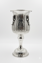 Silver goblet with intricate designs on a white background