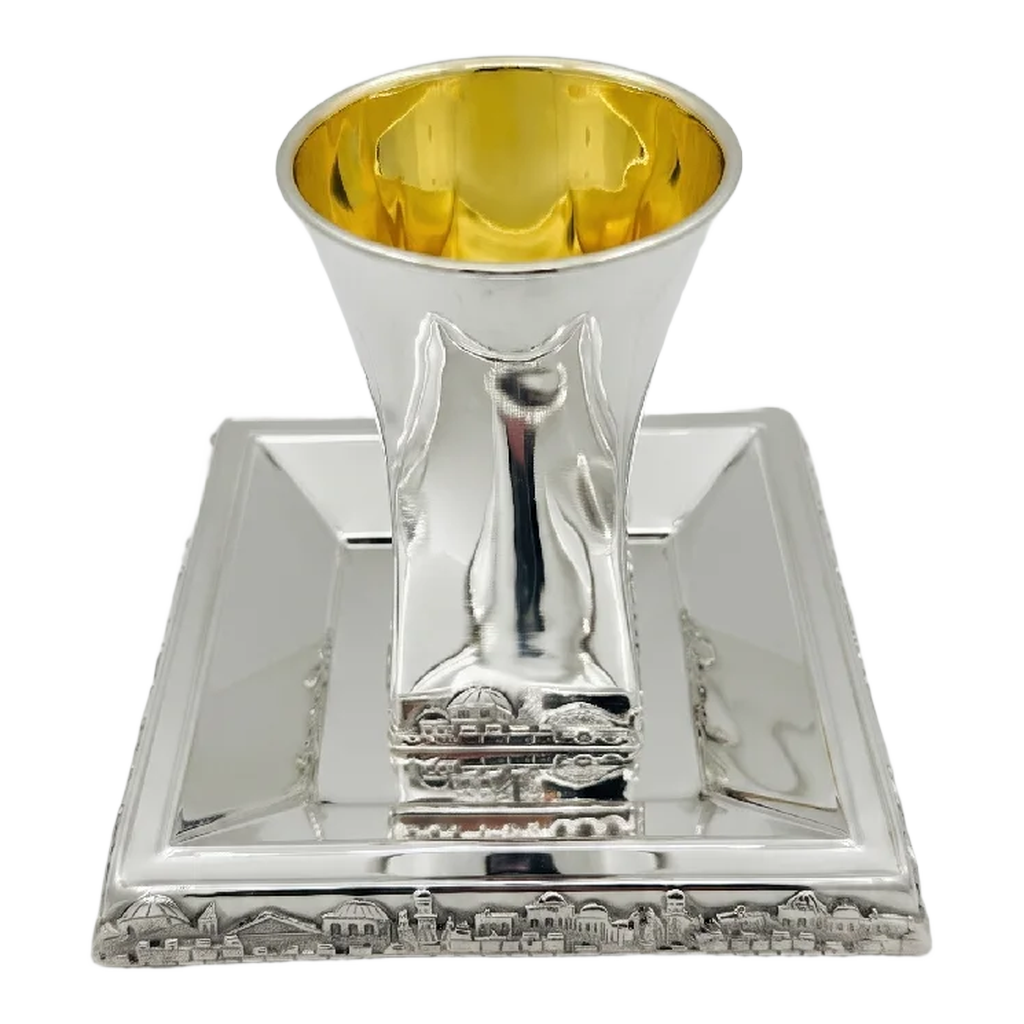 Hadad bros A silver Kiddush cup with a gold interior, set on a matching square silver tray with a decorative Jerusalem cityscape border