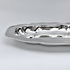 Silver serving dish on a light gray background